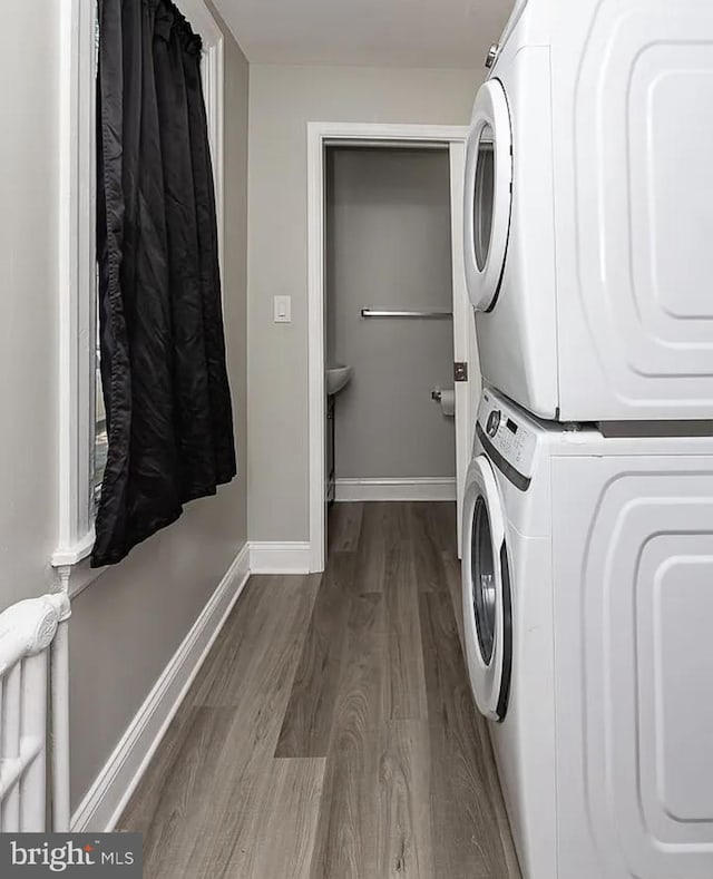 332 E Conestoga Rd, Wayne, PA 19087 - laundry area featuring stacked washer / dryer and dark wood finished floors