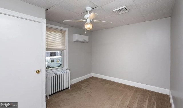 332 E Conestoga Rd, Wayne, PA 19087 - empty room with radiator heating unit, an AC wall unit, carpet floors, ceiling fan, and a paneled ceiling