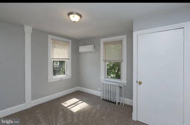 332 E Conestoga Rd, Wayne, PA 19087 - spare room featuring radiator, a wall mounted air conditioner, plenty of natural light, and carpet