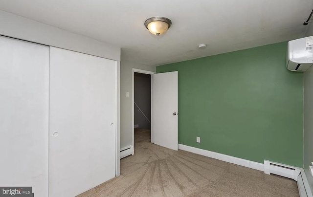 332 E Conestoga Rd, Wayne, PA 19087 - unfurnished bedroom with a baseboard radiator, light colored carpet, an AC wall unit, and a closet