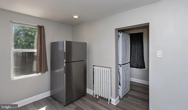 332 E Conestoga Rd, Wayne, PA 19087 - kitchen featuring freestanding refrigerator, estacked washer and dryer, wood finished floors, and radiator