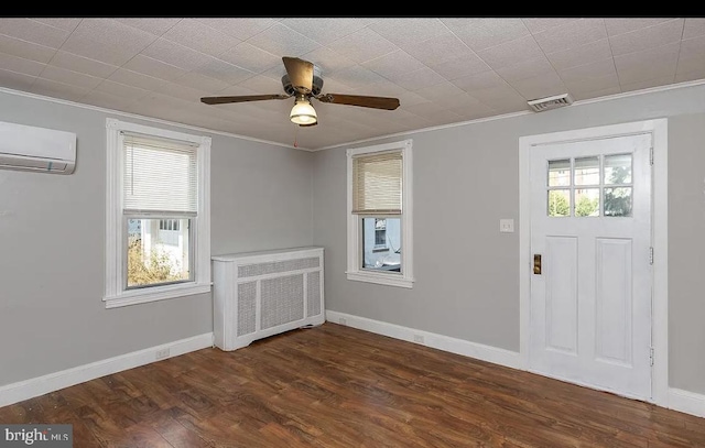 332 E Conestoga Rd, Wayne, PA 19087 - foyer entrance with radiator heating unit, a wall mounted AC, crown molding, a ceiling fan, and dark wood finished floors