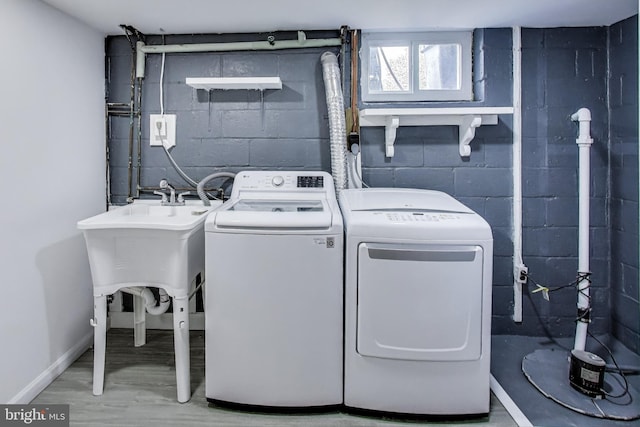 3520 Meadowside Rd, Gwynn Oak, MD 21207 - laundry room featuring concrete block wall, washer and clothes dryer, and wood finished floors