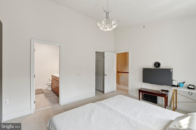 406 Regatta Dr, Philadelphia, PA 19146 - bedroom with a high ceiling, light carpet, a chandelier, and connected bathroom
