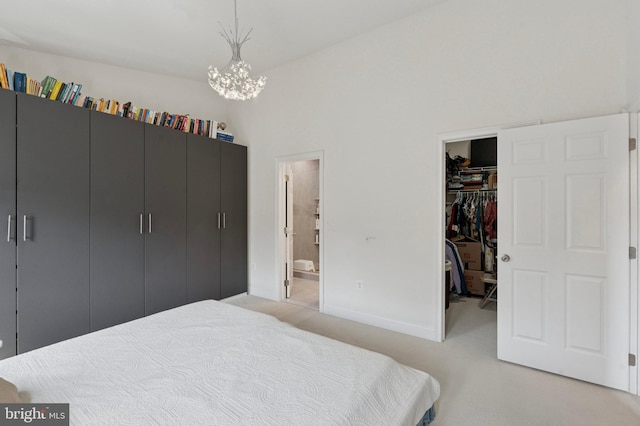 406 Regatta Dr, Philadelphia, PA 19146 - bedroom with a walk in closet, a chandelier, a closet, light colored carpet, and ensuite bath
