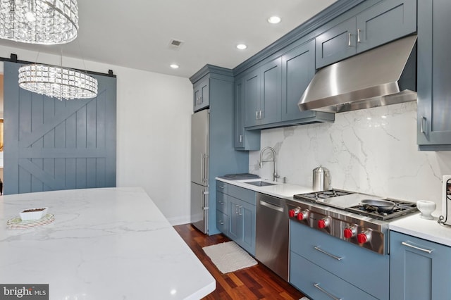 406 Regatta Dr, Philadelphia, PA 19146 - kitchen with range hood, appliances with stainless steel finishes, a chandelier, dark wood-style flooring, and tasteful backsplash