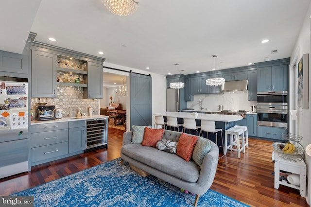 406 Regatta Dr, Philadelphia, PA 19146 - living area featuring beverage cooler, a barn door, dark wood-style flooring, recessed lighting, and a chandelier