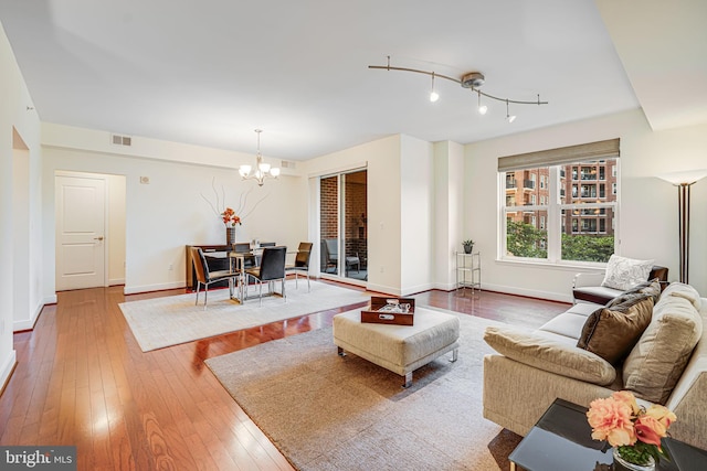 12500 Park Potomac Ave Unit 409, Potomac, MD 20854 - living area with a chandelier and hardwood / wood-style flooring