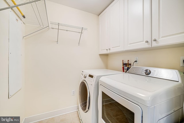 12500 Park Potomac Ave Unit 409, Potomac, MD 20854 - laundry area featuring cabinet space, washer and clothes dryer, and light tile patterned floors