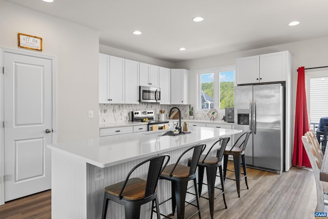 3028 Horizon Rd, Charlottesville, VA 22902 - kitchen featuring appliances with stainless steel finishes, a breakfast bar, white cabinetry, decorative backsplash, and recessed lighting