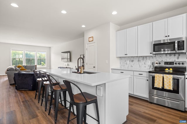3028 Horizon Rd, Charlottesville, VA 22902 - kitchen featuring stainless steel appliances, open floor plan, an island with sink, dark wood finished floors, and white cabinets