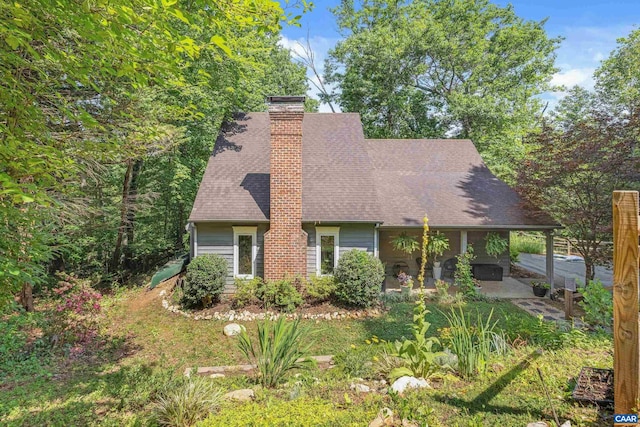 295 Homestead Ln, Charlottesville, VA 22902 - view of front of home featuring a patio, a chimney, and a shingled roof