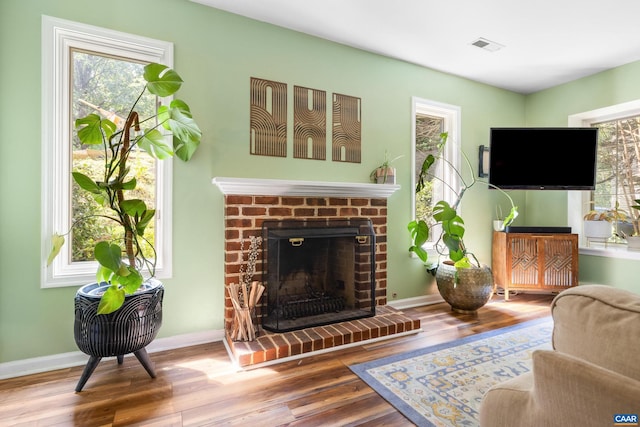 295 Homestead Ln, Charlottesville, VA 22902 - living room with wood finished floors, healthy amount of natural light, and a brick fireplace