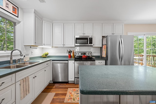295 Homestead Ln, Charlottesville, VA 22902 - kitchen with stainless steel appliances, dark wood-style floors, white cabinetry, backsplash, and dark countertops