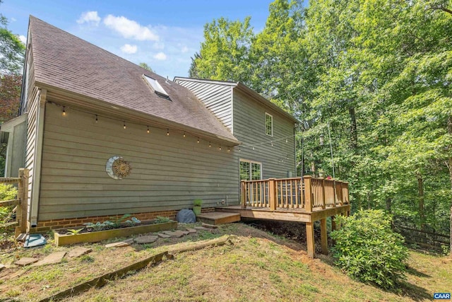 295 Homestead Ln, Charlottesville, VA 22902 - back of property featuring a wooden deck, a shingled roof, and a vegetable garden