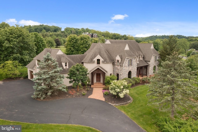3054 Jordan Rd, Orefield, PA 18069 - french country home with stone siding, driveway, stucco siding, and a front yard