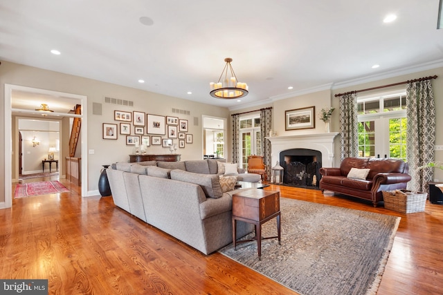 3054 Jordan Rd, Orefield, PA 18069 - living area with a chandelier, light wood-style floors, recessed lighting, a fireplace, and crown molding