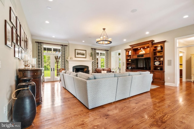 3054 Jordan Rd, Orefield, PA 18069 - living area featuring french doors, ornamental molding, plenty of natural light, light wood-style floors, and recessed lighting