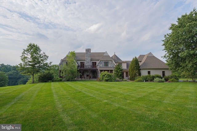 3054 Jordan Rd, Orefield, PA 18069 - rear view of house with stone siding, a lawn, and a chimney