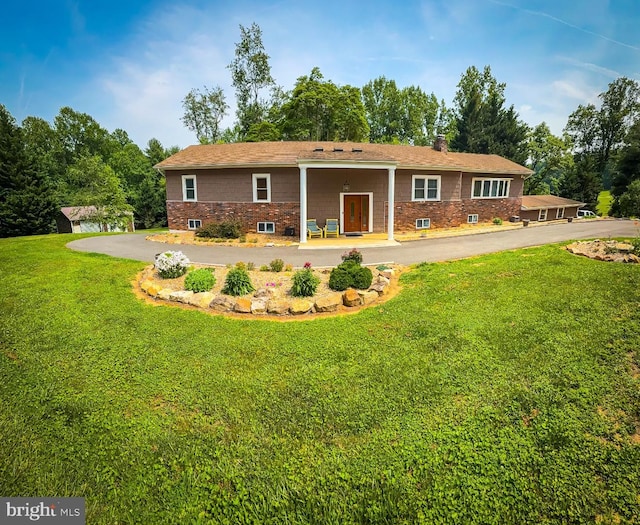 13033 Bottom Rd, Hydes, MD 21082 - back of property with a yard, a chimney, driveway, and view of scattered trees