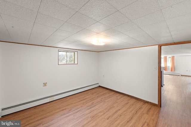 412 Fairview Ave, Winchester, VA 22601 - below grade area with a baseboard heating unit, light wood finished floors, and a baseboard radiator