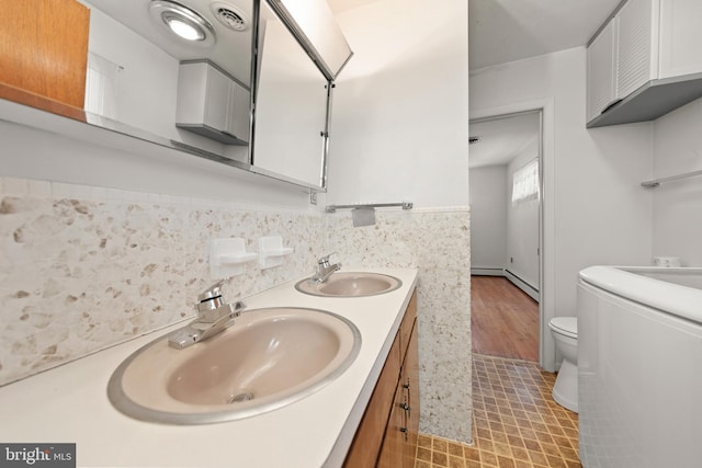 412 Fairview Ave, Winchester, VA 22601 - full bath with double vanity, tile patterned floors, and washer / dryer