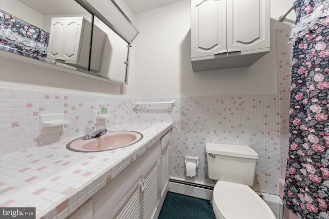 412 Fairview Ave, Winchester, VA 22601 - bathroom featuring tile walls, vanity, a baseboard heating unit, curtained shower, and a wainscoted wall