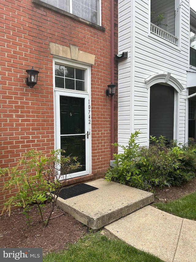 10742 Symphony Way Unit 103, Columbia, MD 21044 - doorway to property featuring brick siding
