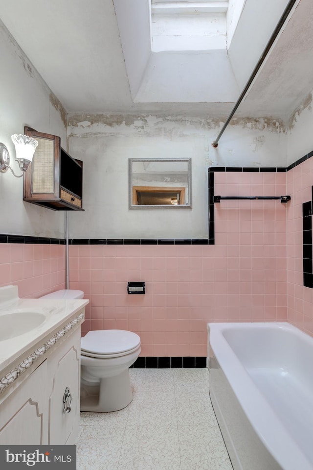257 Westpark Ln, Clifton Heights, PA 19018 - full bathroom featuring tile walls, vanity, a wainscoted wall, and  shower combination