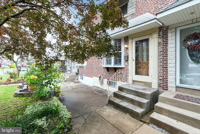 257 Westpark Ln, Clifton Heights, PA 19018 - view of exterior entry featuring brick siding and a patio