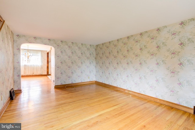 257 Westpark Ln, Clifton Heights, PA 19018 - unfurnished room featuring wood finished floors, a chandelier, and arched walkways
