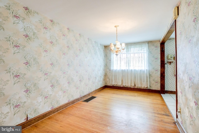 257 Westpark Ln, Clifton Heights, PA 19018 - unfurnished room featuring light wood-style floors, a chandelier, and wallpapered walls