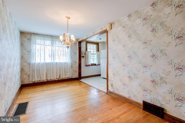 257 Westpark Ln, Clifton Heights, PA 19018 - empty room featuring a chandelier, wood finished floors, and wallpapered walls