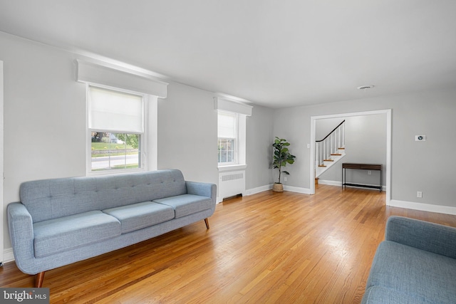 14 Brandywine Blvd, Wilmington, DE 19809 - living area with radiator heating unit, stairway, and light wood-style flooring