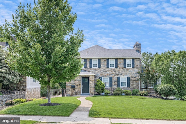 14 Brandywine Blvd, Wilmington, DE 19809 - view of front facade featuring stone siding, a chimney, and a front lawn