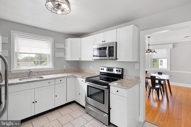 14 Brandywine Blvd, Wilmington, DE 19809 - kitchen featuring appliances with stainless steel finishes, white cabinets, open shelves, and a chandelier