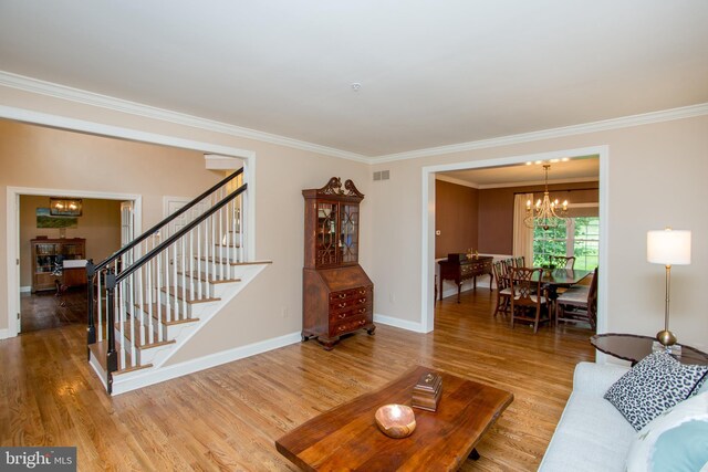 3879 Charter Club Dr, Doylestown, PA 18902 - living area with a chandelier, crown molding, wood finished floors, and stairs