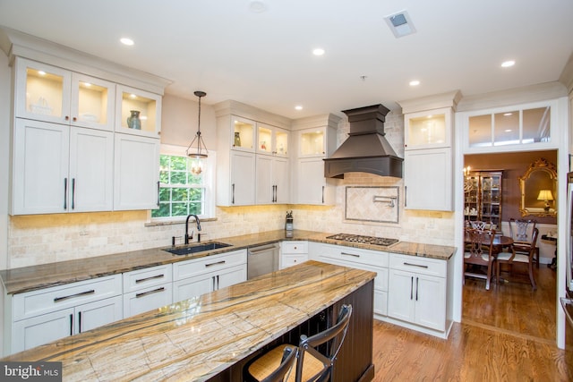 3879 Charter Club Dr, Doylestown, PA 18902 - kitchen with custom range hood, appliances with stainless steel finishes, pendant lighting, light stone countertops, and white cabinetry