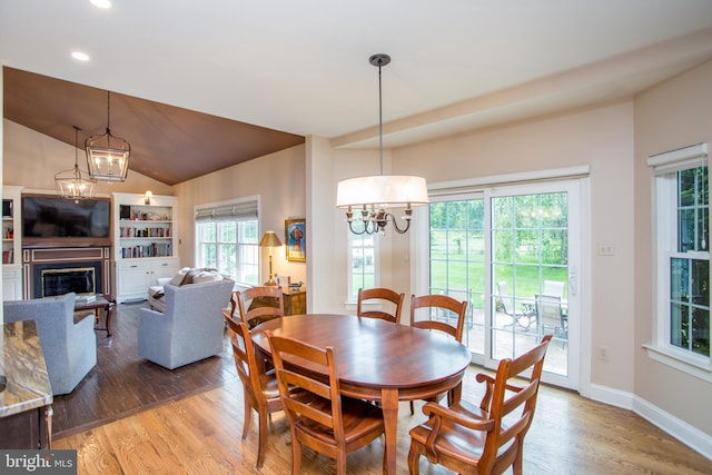 3879 Charter Club Dr, Doylestown, PA 18902 - dining room with a chandelier, wood finished floors, vaulted ceiling, recessed lighting, and a glass covered fireplace
