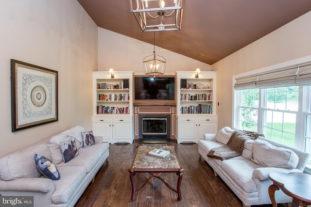 3879 Charter Club Dr, Doylestown, PA 18902 - living room featuring a chandelier, lofted ceiling, dark wood-type flooring, and a glass covered fireplace