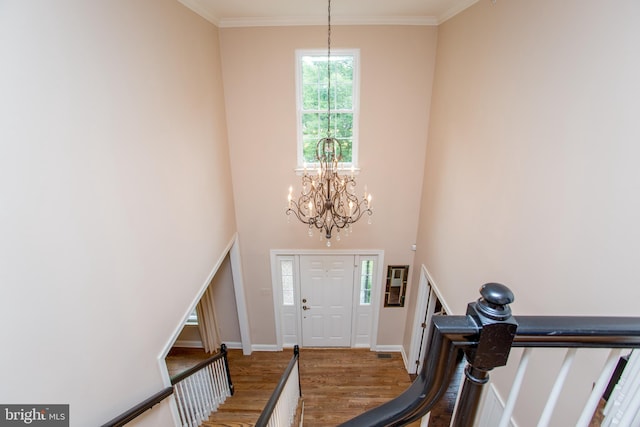 3879 Charter Club Dr, Doylestown, PA 18902 - foyer with wood finished floors, a chandelier, ornamental molding, and a towering ceiling