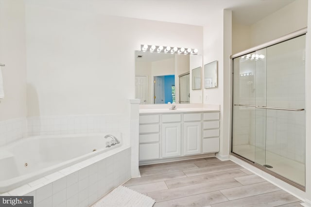 2911 Deer Hollow Way 421 & 422, Fairfax, VA 22031 - full bath featuring a jetted tub, vanity, a stall shower, and wood finished floors