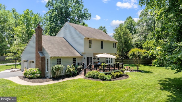 1600 Old Mill Bottom Run, Annapolis, MD 21409 - rear view of house featuring a wooden deck, a chimney, driveway, roof with shingles, and an attached garage