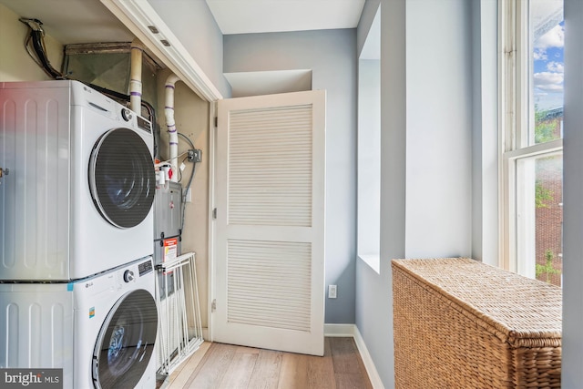 3240 Hiatt Pl NW Unit 4, Washington, DC 20010 - washroom with stacked washing machine and dryer and wood finished floors