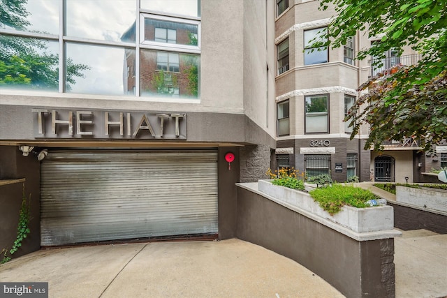 3240 Hiatt Pl NW Unit 4, Washington, DC 20010 - view of property featuring an attached garage and concrete driveway