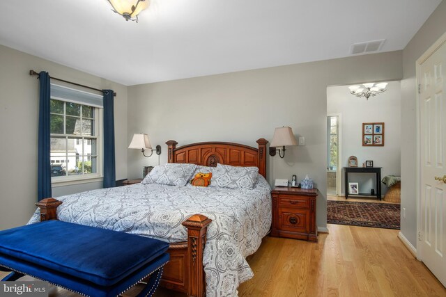 11603 Auburn Grove Ct, Reston, VA 20194 - bedroom with light wood-style floors and a chandelier