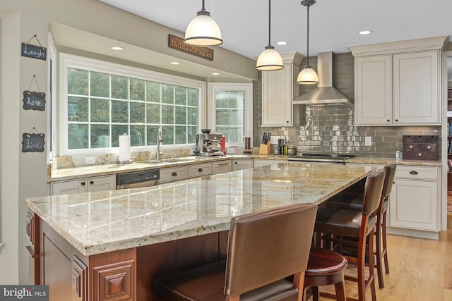 11603 Auburn Grove Ct, Reston, VA 20194 - kitchen featuring wall chimney exhaust hood, dishwasher, light stone countertops, a kitchen island, and a breakfast bar
