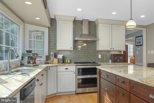 11603 Auburn Grove Ct, Reston, VA 20194 - kitchen featuring wall chimney range hood, stainless steel appliances, backsplash, light wood-style flooring, and pendant lighting
