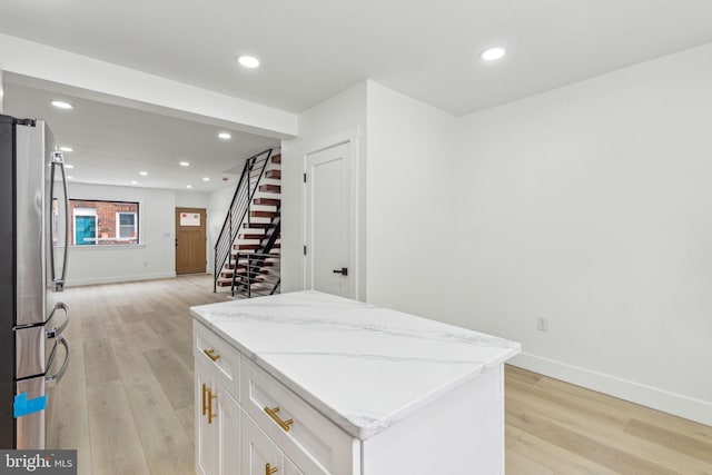 2012 S Mildred St, Philadelphia, PA 19148 - kitchen featuring freestanding refrigerator, light wood-style floors, a center island, white cabinets, and recessed lighting