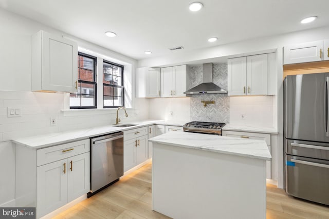 2012 S Mildred St, Philadelphia, PA 19148 - kitchen featuring wall chimney exhaust hood, appliances with stainless steel finishes, light wood finished floors, light stone countertops, and recessed lighting